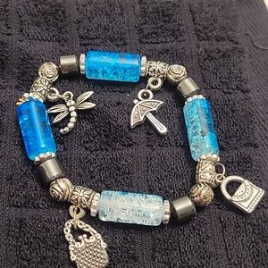 Silver charm bracelet with blue beads